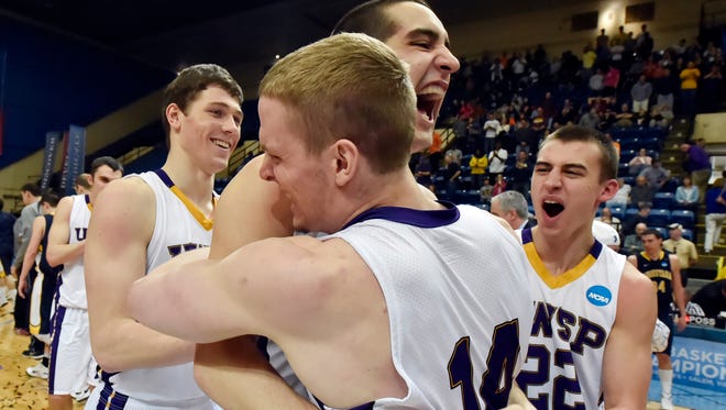 Wisconsin-Stevens Point players, left to right, Zack Goedeke, Jaron Gjertson, Aaron Retzlaff and Caden Untiedt, celebrate defeating Augustana, after the second half of an NCAA Division III college basketball championship game at the Salem Civic Center, Saturday, March 21, 2015, in Salem, Va.  Wisconsin-Stevens Point won 70-54. (AP Photo/Don Petersen)