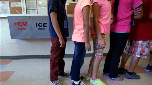 FILE - In this Sept. 10, 2014 file photo, detained immigrant children line up in the cafeteria at the  Karnes County Residential Center,  a temporary home for immigrant women and children detained at the border, in Karnes City, Texas. The Homeland Security Department has privately acknowledged that a remarkable number of young families caught crossing the border illegally earlier this year subsequently failed to meet with federal immigration agents, as they were instructed. At the meeting, the ICE official acknowledged the no-show figures while explaining the administration?s decision in June to open a temporary detention center for families in Artesia, New Mexico. A second immigration jail in Texas was later converted for families and can house about 530 people. A third such detention center will open in Texas later this year. Before the new facility in Artesia, the government had room for fewer than 100 people at its only family detention center in Pennsylvania.  (AP Photo/Eric Gay, File)