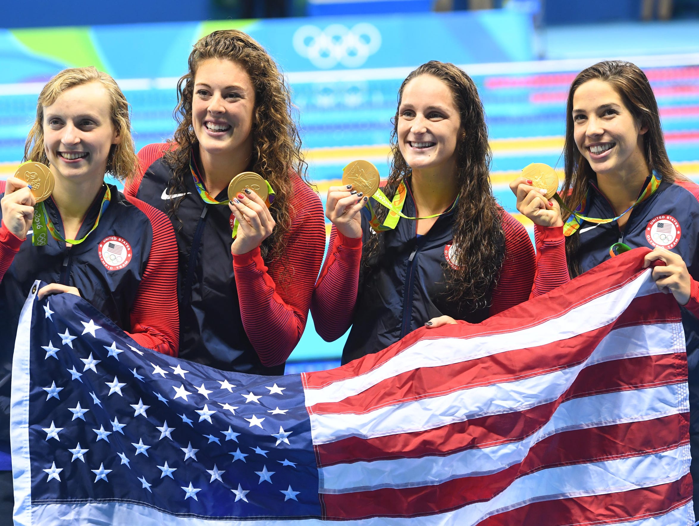 Allison Schmitt, second from left, celebrates her gold