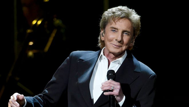 Singer and songwriter Barry Manilow performs at the BB&T Center in Sunrise, Fla., on Friday, Feb. 5, 2016. The singer was hospitalized Thursday, Feb. 11, 2016, because of complications from oral surgery.