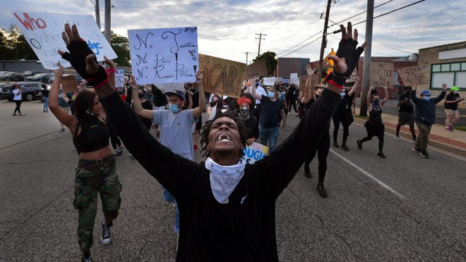 Protesters march on South Florissant Road in front of the Ferguson police station on Saturday, May 30, 2020, demonstrating against the death of George Floyd in custody of Minneapolis police officers.Photo by Robert Cohen, rcohen@post-dispatch.com