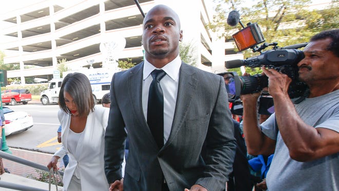 Minnesota Vikings running back Adrian Peterson enters the Montgomery county courthouse for his arraignment.