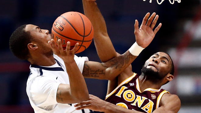 Monmouth's Je'lon Hornbeak drives to the basket against Iona's  forward Aaron Rountree  during the first half of Monday night's MAAC Championship final in Albany, N.Y.