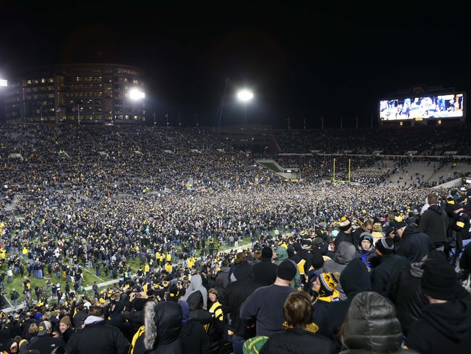 Fans storm the field after Iowa Hawkeyes place kicker