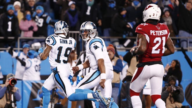 Carolina Panthers' Ted Ginn Jr. runs for a touchdown with Cam Newton past Arizona Cardinals' Patrick Peterson in the first quarter at the NFC Championship game on Jan. 24, 2016 in Charlotte, North Carolina.