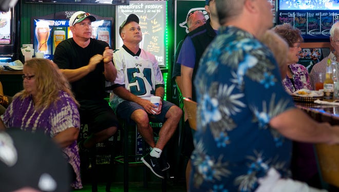 Philadelphia Eagle fans watch their team play the Washington Redskins on a TV at the Greene Turtle in Ocean City.