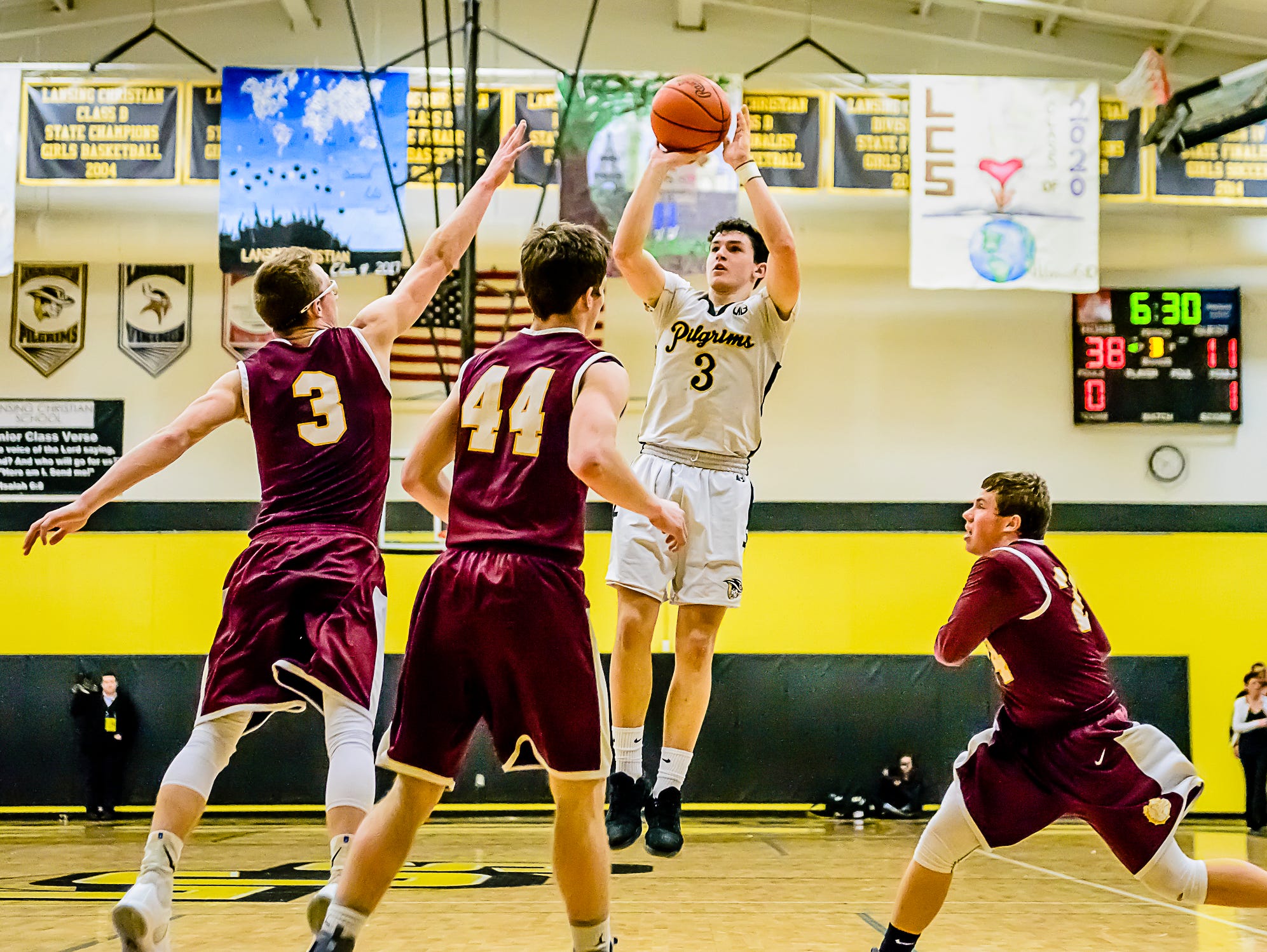Matt Havey ,3, of Lansing Christian shoots over several Morenci defenders during their Class D regional semifinal Monday.