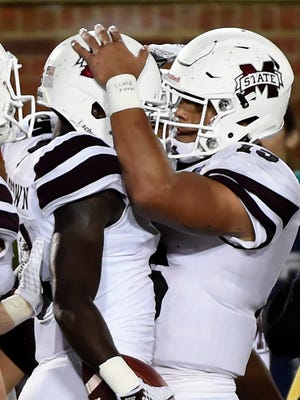 Mississippi State quarterback Dak Prescott, right, and wide receiver Fred Brown celebrate after Brown caught an eight-yard touchdown pass from Prescott during the second half of an NCAA college football game against Missouri on Thursday, Nov. 5, 2015, in Columbia, Mo. (AP Photo/L.G Patterson) 