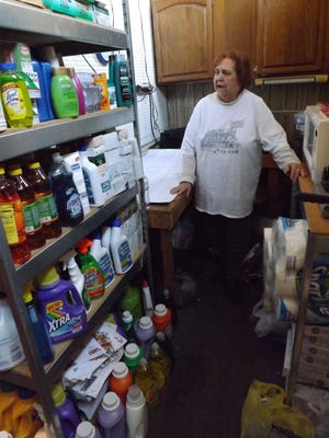 Vicki Brim, executive director of Senior Opportunities Services, shows the usually bare shelves of the senior soap pantry full of items thanks to donations during the P-I's 12 Months of Giving campaign.