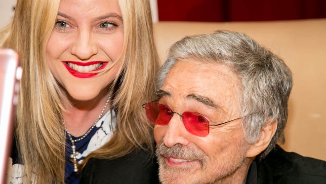 Fan Tabitha Hall Blount  interacts with Burt Reynolds at the star's June 1 "An Evening with Burt Reynolds" event at the Eissey Theatre in Palm Beach Gardens.
