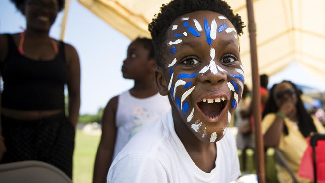 Jole Gorman, 8, reacts to seeing her face painted at the June 16 celebration at the Martin Luther King Center in Wilmington in 2018.