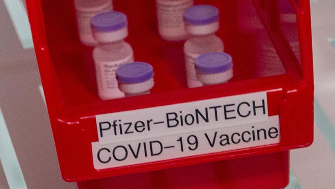 Vials of Pfizer-BioNTech COVID-19 vaccine sit in a refrigerator at Ochsner Hospital in Baton Rouge, La.
