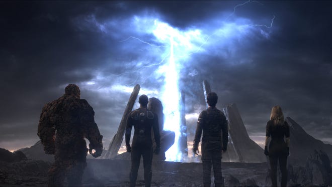 This photo provided by courtesy Twentieth Century Fox shows, The Thing, from left, Michael B. Jordan as Johnny Storm, Miles Teller as Dr. Reed Richards, and Kate Mara as Sue Storm, in a scene from the film, "Fantastic Four," releasing in U.S. theaters on Aug. 7, 2015. (Twentieth Century Fox via AP)