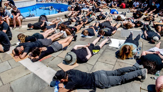 Hundreds of protesters line face down on the pavement during the Are We Next rally Sunday, June 7, 2020 at the Peoria County Courthouse. The peaceful protest organized by the Young Revolution group attracted about 1,000 people.