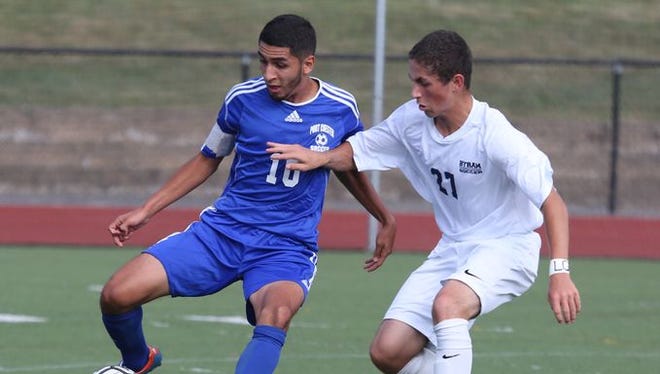 Port Chester's Steven Hernandez moves the ball in front of Byram Hills' Michael Bordash during a game in Armonk on Sept. 4, 2015.