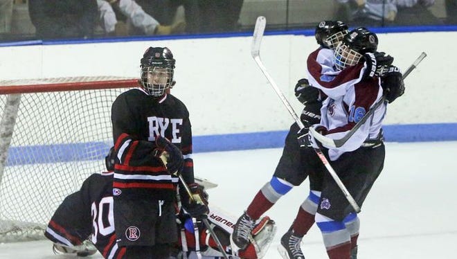 Rye Town/Harrison's Sam Adler, right, scored the first goal of the game as Rye and Rye Town/Harrison battled in a Division II playoff game at the Playland Ice Casino Feb. 23, 2015.