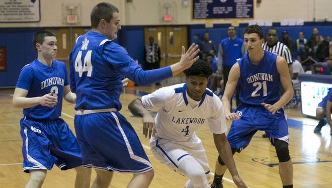 On the far left, Riley Collins (3) plays against Lakewood on Jan. 4.