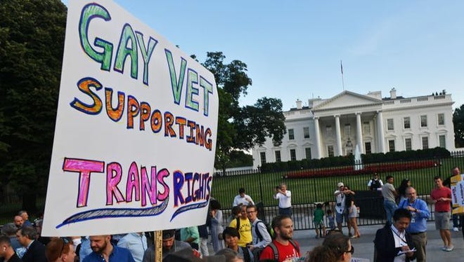 Protesters gather in front of the White House on July 26, 2017, in Washington, DC. Trump announced on July 26 that transgender people may not serve "in any capacity" in the US military, citing the "tremendous medical costs and disruption" their presence would cause.