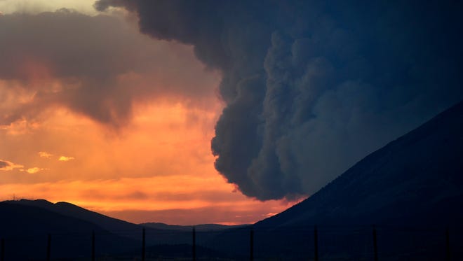 The large plume of the Spring Fire silhouetted by the setting sun late Wednesday,July 4, 2018, in La Veta, Colo. (Helen H. Richardson/The Denver Post via AP)