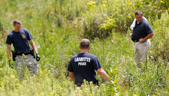 Lafayette Police Department officers look for evidence following the discovery of a body found in a drainage  ditch Monday, July 31, 2017, behind Promenade Self Storage, 3700 Promenade Parkway on the south side of Lafayette.