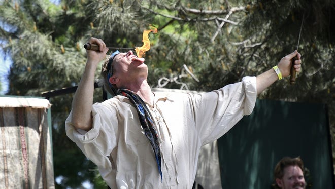 A performer breaths fire at the 29th annual Tulare County Renaissance Fair at Plaza Park on Saturday, April 21, 2018.
