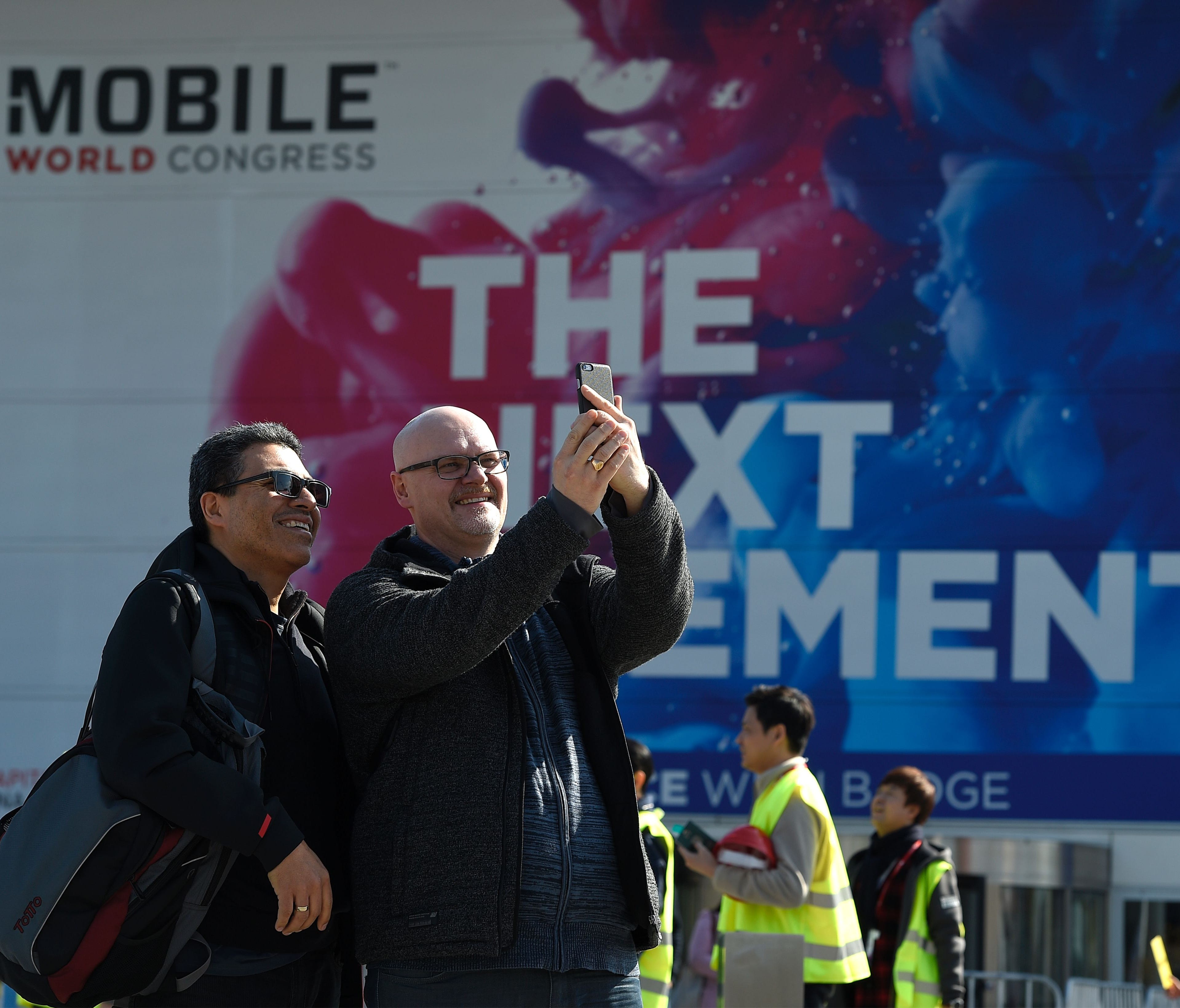 People take selfies outside the Mobile World Congress in Barcelona on Feb. 25, 2017, before the start of the world's biggest mobile fair, held from Feb. 27 to 2 Mar.