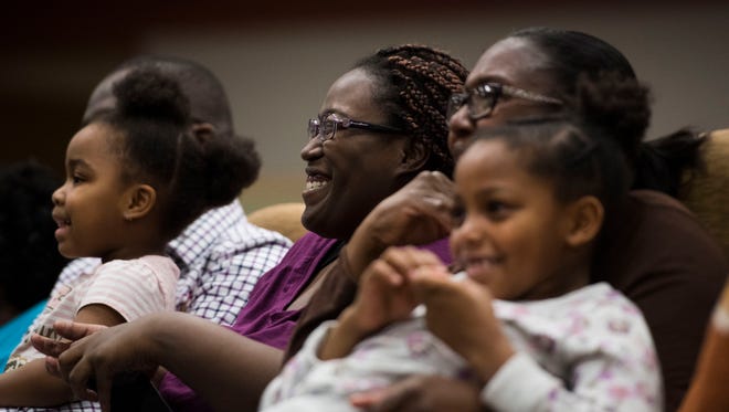At center Annitrice Strickland laughs as a video is shown featuring her grandmother during a women's history month event honoring her grandmother Kattie Strickland, an African American woman who worked as a janitor during the Manhattan Project, at the New Hope Visitor Center at Y-12 Thursday, March 22, 2018.