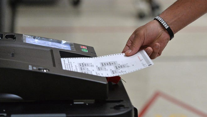 A voter feeds their paper ballot into a ballot reader during the primary election, June 2, 2020, at the Millcreek Township 23rd District polling place at First Alliance Church, 2939 Zimmerly Road. The voter registration margin between Democrats and Republicans has tightened in the past year. Erie County officials say it is due to a voter purge done earlier in the year, as well as Erie's population decline and voters switching over to the GOP.