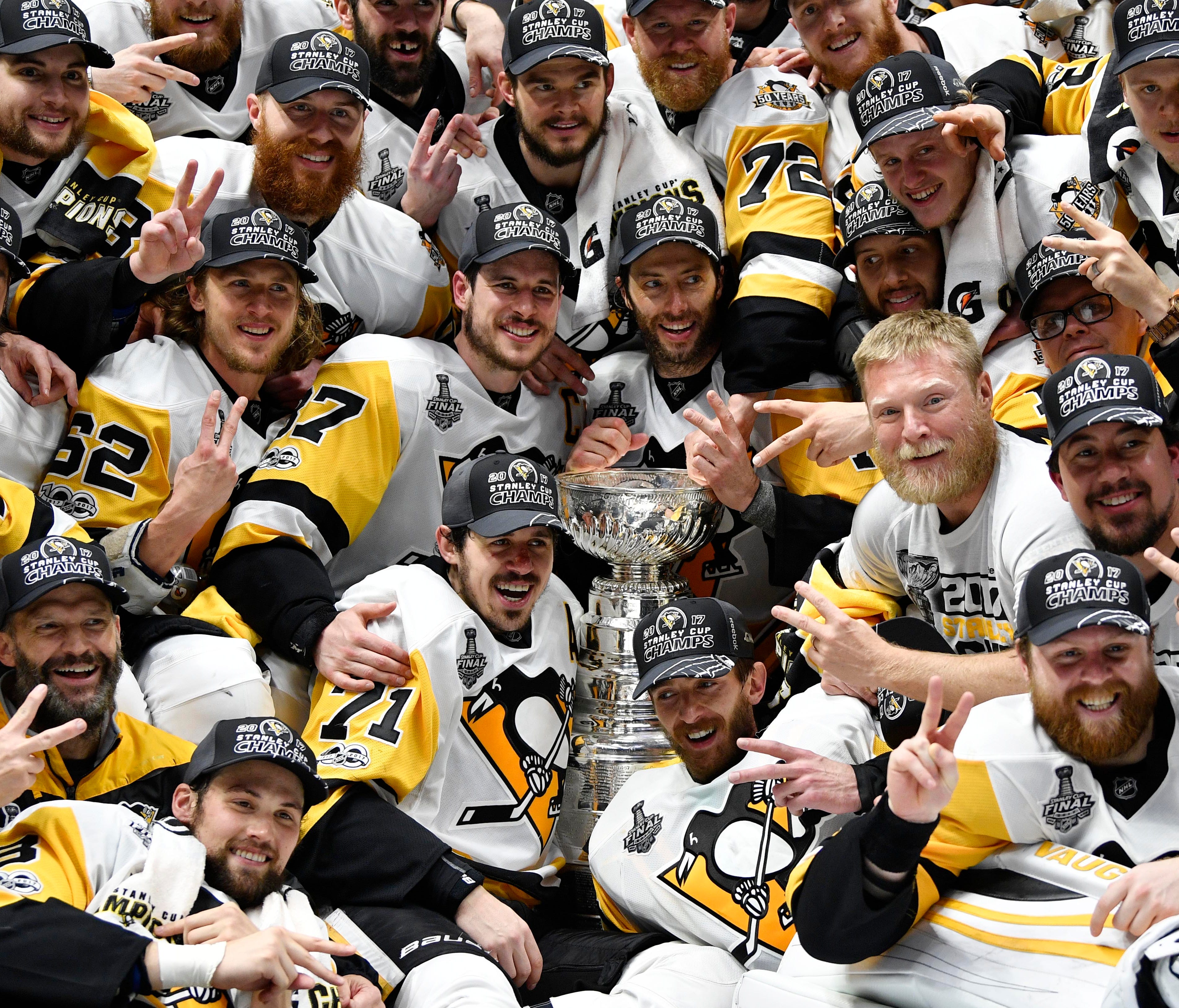 The Pittsburgh Penguins pose for a team photo with the Stanley Cup.