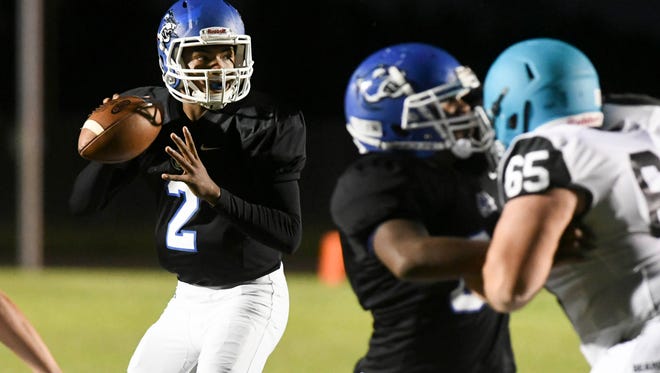 Nigel Scott of Heritage drops back to pass during Thursday's game against Bayside. 