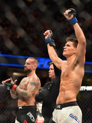 Mickey Gall (right), a Green Brook native and Rutgers product, is proclaimed the winner over C.M. Punk (left) during UFC 203 at Quicken Loans Arena in Cleveland on Saturday.