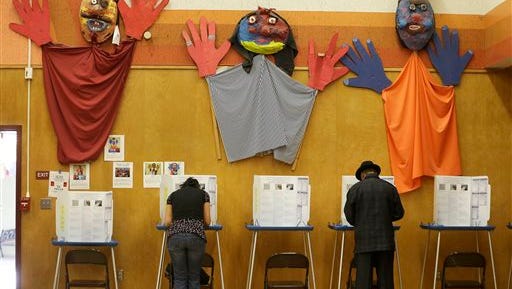Voters cast their ballot at Manzanita Community School Tuesday in Oakland, Calif. An exit poll has shown that party leaders are a drag on both sides.