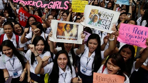 Students from St. Scholastica's College, a Catholic school in Manila, shout slogans during a protest outside their campus June 27, 2014. Thousands of Filipino students from the Roman Catholic-run school for girls joined Friday a global campaign to free more than 200 schoolgirls abducted by Islamic extremists in Nigeria, chanting "bring them back" and urging motorists in the Philippine capital to honk their car horns in solidarity.