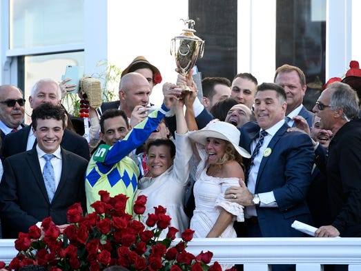 Always Dreaming's team celebrates in the winner's circle