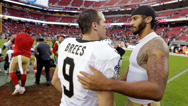 FILE - In this Nov. 6, 2016, file photo, San Francisco 49ers quarterback Colin Kaepernick, right, is greeted by New Orleans Saints quarterback Drew Brees at the end of an NFL football game in Santa Clara, Calif. As athletes and sports organizations around the world speak out against racial injustice in the wake of George Floyd’s death, Drew Brees drew sharp criticism after he reiterated his opposition to Colin Kaepernick’s kneeling during the national anthem in 2016. (AP Photo/D. Ross Cameron, File)