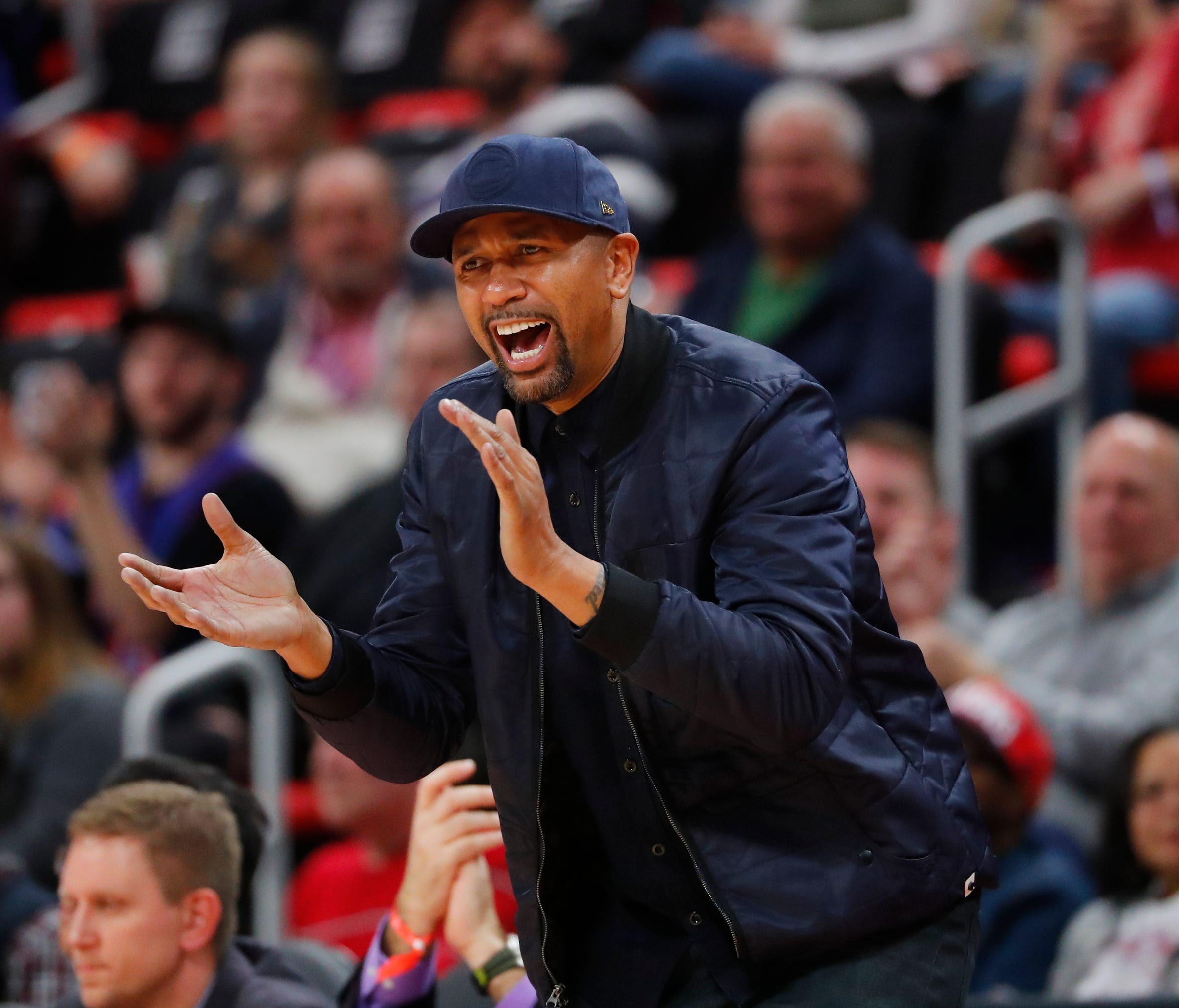 Jalen Rose cheers in the second half of an NBA basketball game between the Detroit Pistons and New Orleans Pelicans in Detroit, Monday, Feb. 12, 2018.