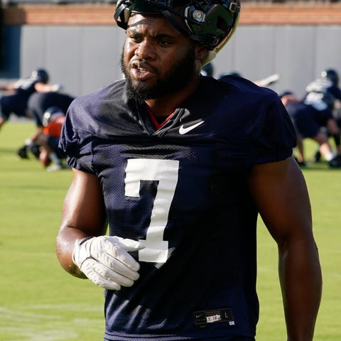 FILE - Virginia running back Mike Hollins takes a 