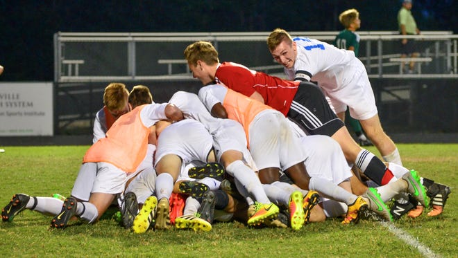 Eastside players celebrate after Brian Acevedo's goal in the second sudden-death overtime period gave the Eagles a 2-1 win over visiting Aiken in the Class AAAA Upper State final Tuesday night.