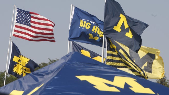 Tailgaters fly their flags  outside of Michigan Stadium on Sept. 3, 2011, in Ann Arbor.