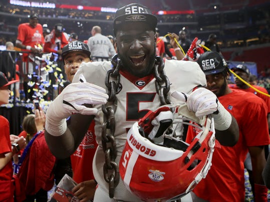 Georgia defensive lineman Julian Rochester celebrates after making his way off the stage after Georgia defeated Auburn 28-7 during the Southeastern Conference championship NCAA college football game Saturday, Dec. 2, 2017, in Atlanta, Ga. (C.B. Schmelter/Chattanooga Times Free Press via AP)