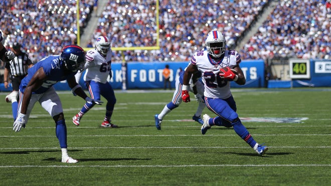 Sep 15, 2019; East Rutherford, NJ, USA; Buffalo Bills running back Devin Singletary (26) runs for a touchdown against New York Giants cornerback DeAndre Baker (27) during the second quarter at MetLife Stadium. Mandatory Credit: Brad Penner-USA TODAY Sports