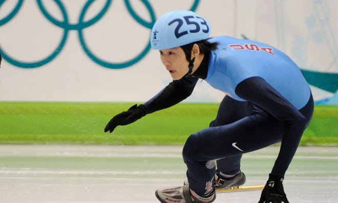 Simon Cho follows Korea's Lee Ho-Suk in a heat of the 500 meter short track speed skating at the Vancouver Olympics.