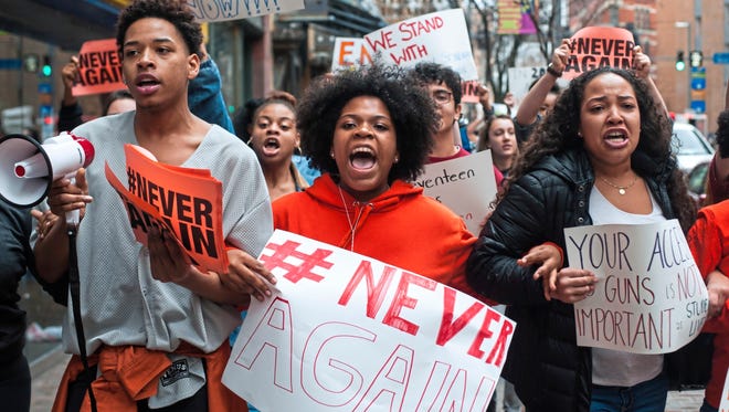 High school students Mia Arrington, center, 18, of West End, and Cheyenne Springette, right, 17, of Mt. Oliver, lead chants as they march down Liberty Avenue during a walk-out in solidarity with other high schools across the country to show support for Parkland, Fla, students on Wednesday, Feb. 21, 2018, in downtown Pittsburgh. In a wave of demonstrations reaching from Arizona to Maine, students at dozens of U.S. high schools walked out of class Wednesday to protest gun violence and honor the victims of last week's deadly school shooting in Florida.