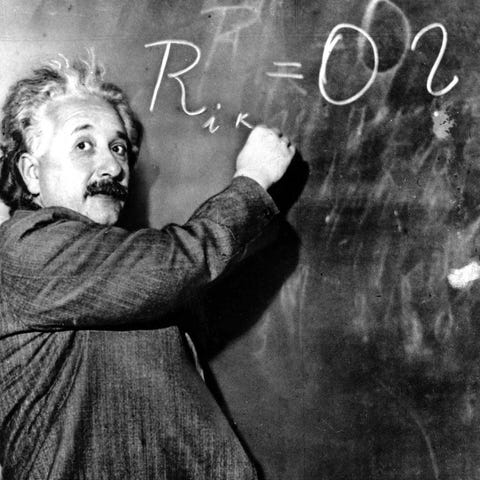 Albert Einstein writes out an equation for the den