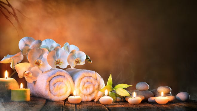 Two Towels, Bamboo, candles and pebble of Stones For Natural Massage