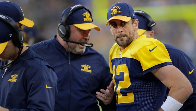 Green Bay Packers head coach Mike McCarthy talks to Aaron Rodgers on the sidelines after Rodgers fumbled the ball near the goal line in the second half against the Dallas Cowboys at Lambeau Field.
