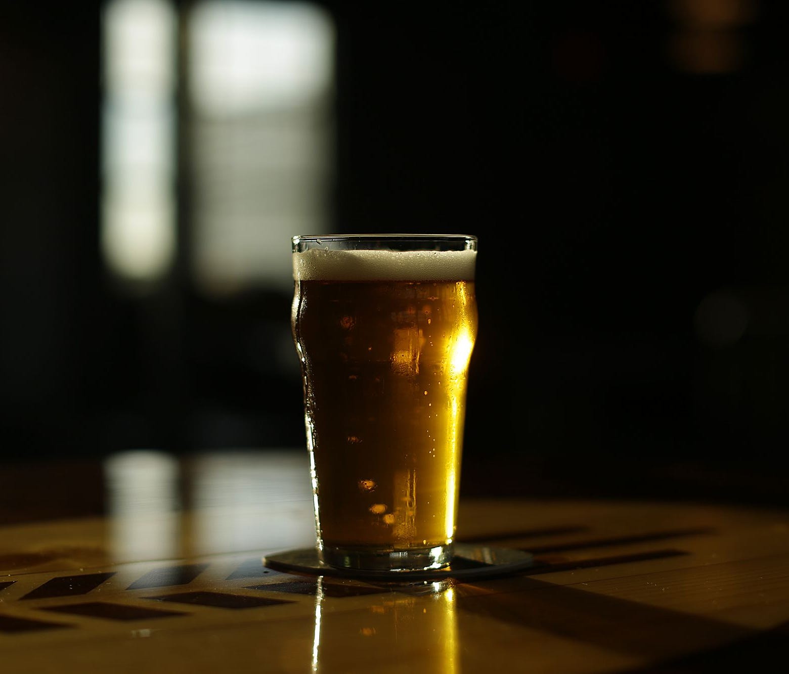 A beer sits on a table in downtown Green Bay.