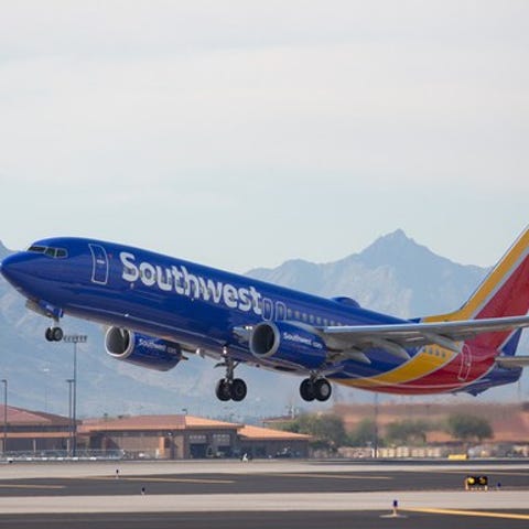 A Southwest airplane takes off from a runway.