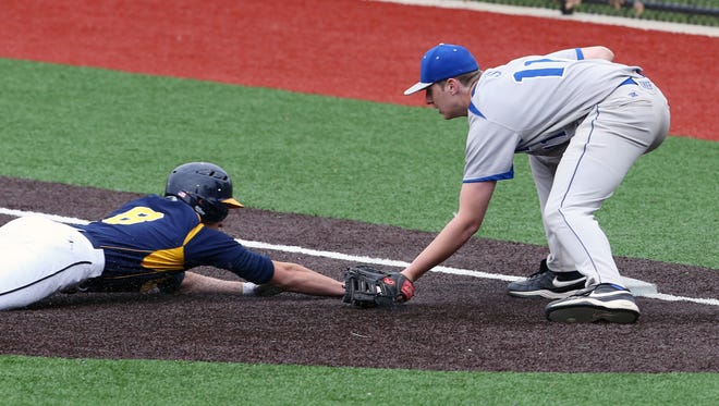 Sayreville vs. Colonia varsity baseball  held at Colonia High School on Thursday April 28, 2016.Sayreville 1st baseman # 11 (right) Jayson DeMild tags out a sliding  # 8 Colonia's Mike Parry. 