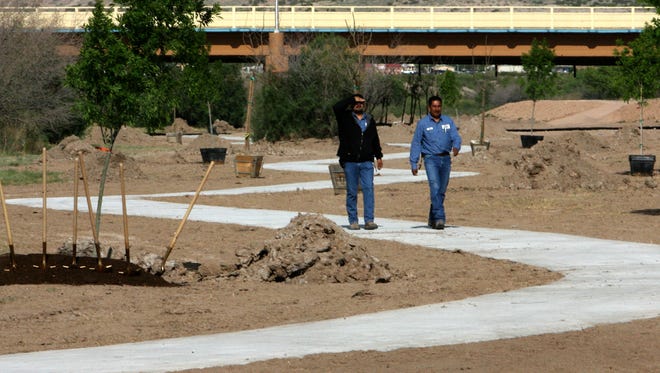 Robert Hernandez, left, and a fellow Sunland Park municipal employee walk along the Rio Grande River Trail in this April 2010 photo. The Paso del Norte Health Foundation is seeking public input during two meetings this week on the creation of a master plan for the proposed Paso del Norte Trail. The trail is a 50-mile linear trail that links the Upper Valley to San Elizario and would integrate existing trails such as the Rio Grande River Trail.